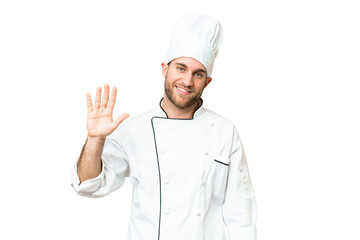 Wall Mural - Young blonde man Chef over isolated chroma key background counting five with fingers