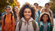A diverse multicultural group of self-assured teenagers walk together after high school.