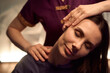 © Svitlana - Skilled masseuse stretching female client neck during Thai massage session