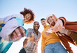 © Wesley/peopleimages.com - Friends, selfie and hands outdoor for social media, fashion and fun adventure. Below diversity, youth and portrait of student group or men and woman for profile picture, memory and freedom in nature