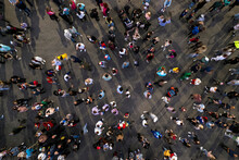 Crowd People Background. An Aerial Shot Of The People Gathered For An Event. Crowed Open-air Meeting People Shot From A Height. A Mass People Gathered To Celebrate An Event. Open-air Night Festival.