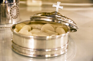 Wall Mural - Silver bowl for the priest with tablets which are the body of Jesus and are given to the altar