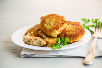 Poster - Cooked fried fish cutlets in a plate with herbs.