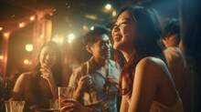 Asian Adults Laughing And Drinking Having Fun At A Party In A Bar