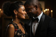 A stunning black couple in formal attire smiles shyly at each other eyes ling in a moment of tenderness.