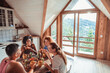 © Marko Geber - Young and diverse group of female friends having breakfast together in a cabin in the mountains