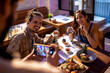 © Marko Geber - Waiter taking a photo with a smart phone of a young couple on a date in a sushi restaurant