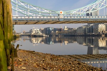 Canvas Print - a long bridge over a river in the city with many buildings