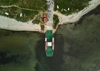 Canvas Print - Aerial view of a large vessel docked in a port, with a body of water in the background