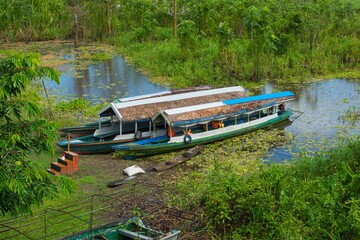 Canvas Print - two boats on a body of water with trees behind them