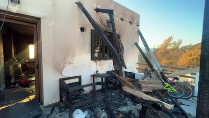 Poster - Exterior shot of an old white abandoned house with destroyed walls in the village