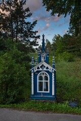 Sticker - blue and white building with white roof in rural area with trees