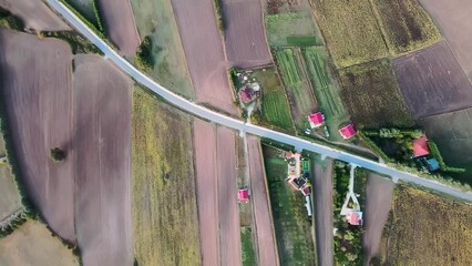 Wall Mural - drone shot over countryside houses with colorful fields