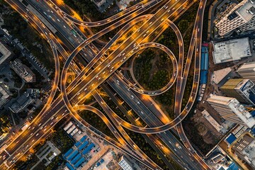 Wall Mural - Shot of a bustling city intersection at night with cars driving on the illuminated roads