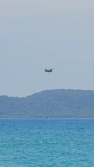 Canvas Print - Belarusian firefighting helicopter flying over the sea to help extinguish a fire in Antalya