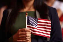 Female Immigrant Holding A Small US Flag The Day Of Her Naturalization Ceremony