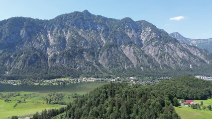 Wall Mural - Aerial video of buildings and a lake surrounded by rocky mountains