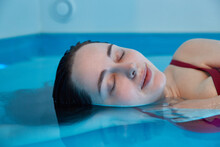 A Relaxed Young Woman In The Water. Closed Eyes And Relaxation
