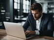 © Damian - Smartly dressed man in sitting in an office hard at work on his laptop