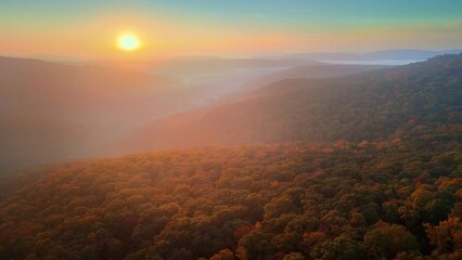 Wall Mural - Sunrise drone aerial over foggy autumn Arkansas ozark mountains with colorful fall forest trees