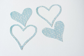 Wall Mural - four machine cut scrapbooking paper hearts and heart-frames on blank paper