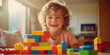 Happy European kid having fun playing with toy bricks constructor at home. Creative wallpaper, activity for children, happy emotion.
