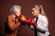 Elderly and Young Woman in Boxing Gloves Stand in Side Stances Opposite Each Other