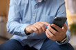 © New Africa - Man sending message on smartphone indoors, closeup