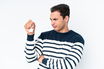 Wall Mural - Young caucasian man holding home keys isolated on white background with sad expression