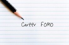 Pencil On Office Paper With Handwritten Text CAREER FOMO, Means Fear Of Missing Out On A Job Opportunity,  The Worry That Everyone Else Is Achieving And Enjoying More Success Than You
