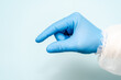 Doctor's hand in blue glove like holding something