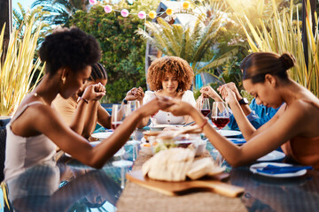 Wall Mural - Food, people and holding hands to pray outdoor at table for gratitude and holiday celebration. Group of friends together at lunch, party or reunion with drinks in garden for thanks, prayer and grace