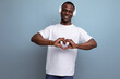 © Ivan Traimak - well-groomed adorable 30s african man with short haircut in white t-shirt enjoying music on headphones