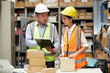 © offsuperphoto - factory workers checking products from clipboard and cardboard box packaging in the warehouse storage