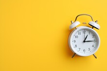 Alarm Clock On A Plain Yellow Background