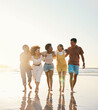 © Anela/peopleimages.com - Summer, space and travel with friends at beach for freedom, support and sunset. Wellness, energy and happy with group of people walking by the sea for peace, adventure and Hawaii vacation mockup