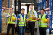 © offsuperphoto - group of workers thumbs up pose after success work in the warehouse storage