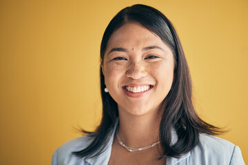 Poster - Face, smile and Asian woman, designer and entrepreneur in studio isolated on a yellow background mockup space. Portrait, happy and creative professional, worker and startup employee in Cambodia.