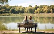© Vladislava - Young lesbian lgbt couple sitting on bench in park, looking at the natural lake view, two women, summer, green. love, AI Generated