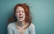 © Vladislava - Closeup portrait photo of young red haired crying attractive woman with unhappy sad face, problem, depressed, offended isolated on modern pastel blue color background, AI Generated