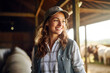 Smiling young woman in a sunlit barn