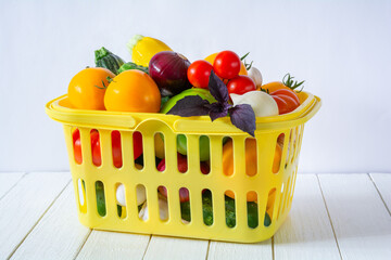 Wall Mural - Fresh ripe vegetables in a yellow basket