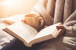 © Yuliia - Close up unrecognizable girl woman reading book in cozy bed bedroom with warm coffee cup tea cocoa mug relaxation comfort read novel hobby relaxing in morning sunny room learning studying at home
