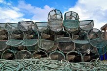 Lobster Pots Or Crab Traps Stacked Up On Tobermory Harbor Quayside, Isle Of Mull, Scotland