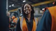 © Fred - Smiling black female mechanical engineer talking to her colleagues