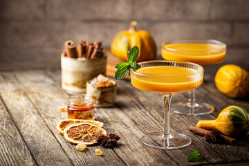 Wall Mural - Pumpkin and orange spiced fall cocktail with cinnamon