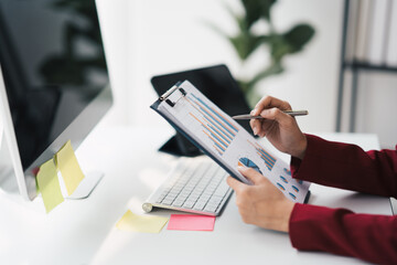 Poster - Hands of a businessman who are working on paperwork while sitting on a desk.