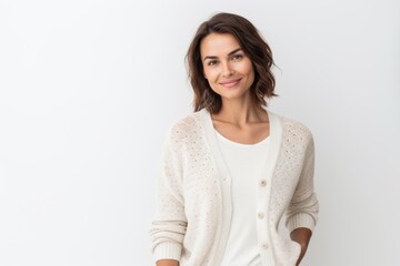 Wall Mural - portrait of smiling young woman in white sweater looking at camera isolated on white