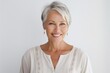 © Anne-Marie Albrecht - Portrait of a smiling senior woman looking at camera over white background