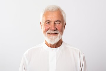 Group portrait of a Russian man in his 70s in a white background wearing a simple tunic